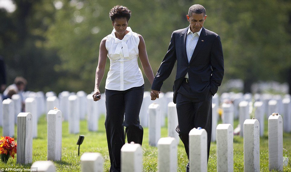 Barack Obama was seen strolling with his wife, Michelle, among graves filled with dead from the Afghanistan and Iraq wars