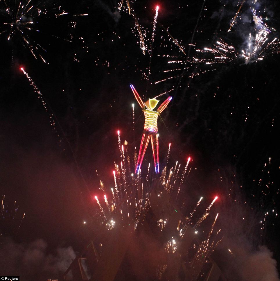 Burning Man 2011, fireworks erupt before The Man is burned during the Rites of Passage in the Nevada desert