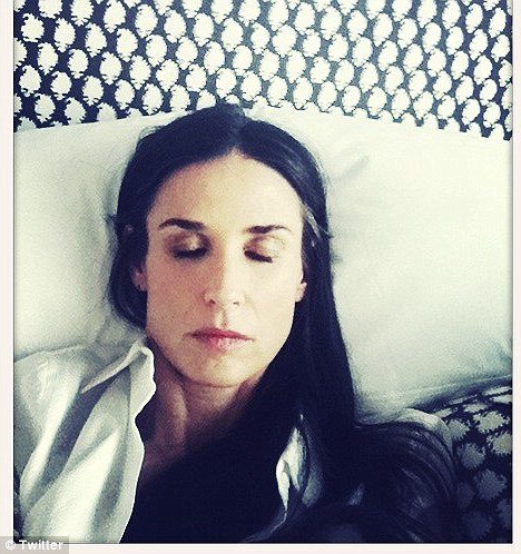 Demi Moore posted a picture of herself with eyes closed, looking solemn, with the words “I see through you”