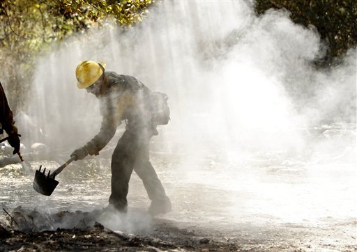 Firefighter from the Lassen National Forest cleans up hot spots in Bastrop Texas (AP Photo/Eric Schlegel)