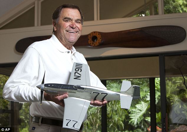 Jimmy Leeward holding a scale model of his P-51 Mustang at his Florida home in 2010