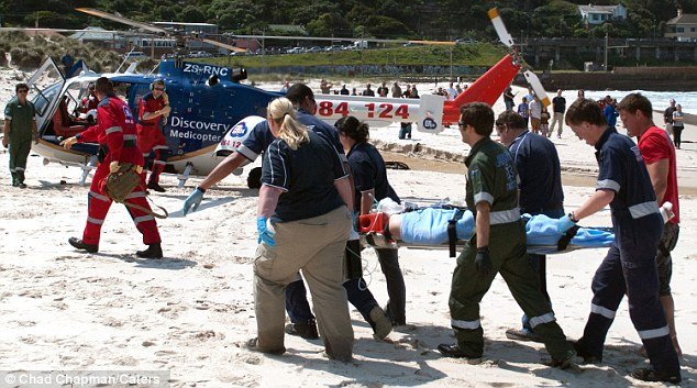Michael Cohen, who has lost his lower right leg and left foot, was carried from the beach by members of the Fish Hoek emergency services to a waiting helicopter