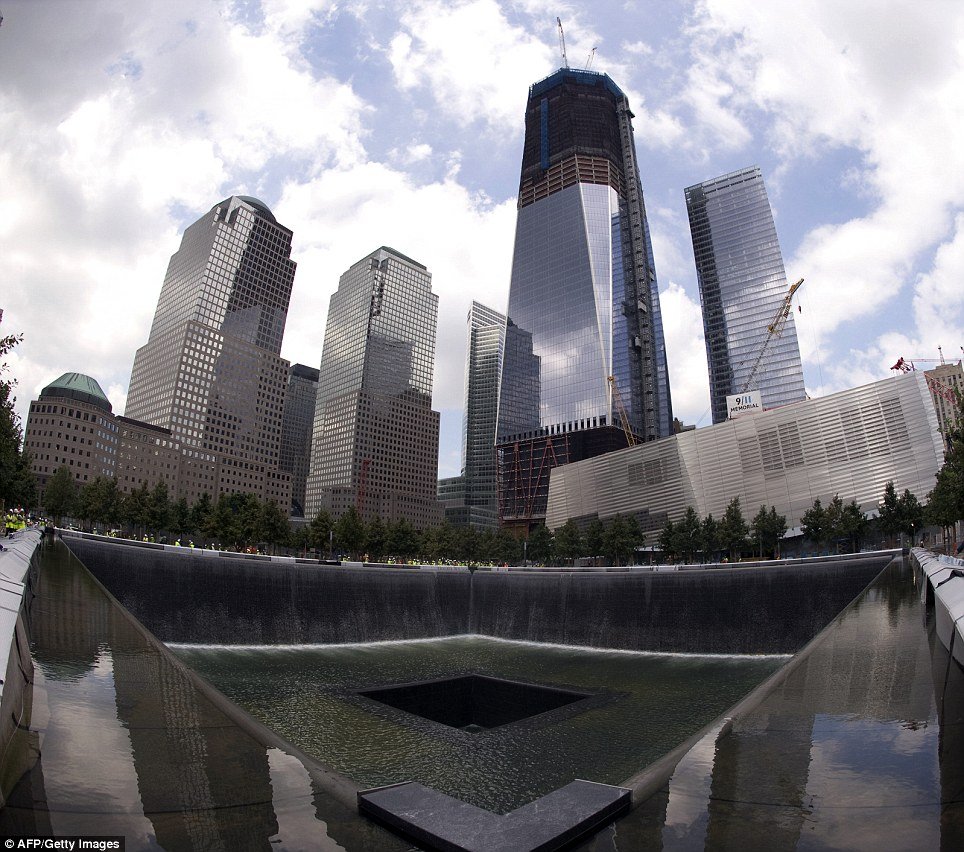 National 9/11 Memorial: view from the south pool waterfall with Freedom Tower in the background