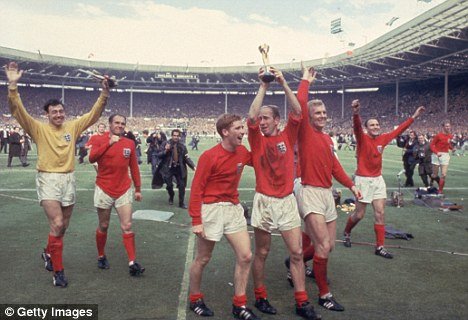 Bobby Charlton raises the World Cup trophy after England beat West Germany 4-2 at Wembley Stadium in 1966