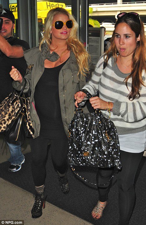Jessica Simpson showed off what appeared to be a baby bump under a tight black Lycra T-shirt
