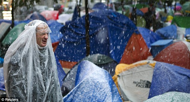 Occupy Wall Street protesters in New York City remained in their tents overnight despite the snowstorm and low temperatures which plunged below 40 degrees F