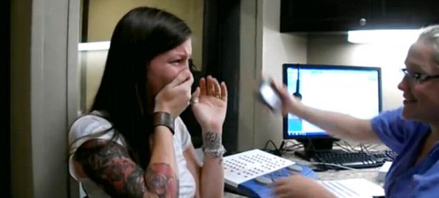 Sarah Churman cries with laughter as she hears the world around her for the first time