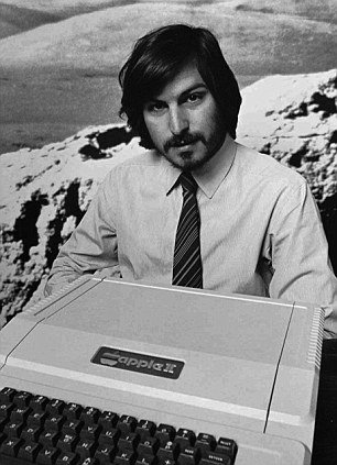 Steve Jobs holds the Apple II computer in 1977