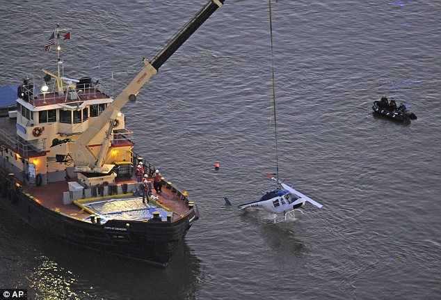 The Bell 206 tourist helicopter, which was not equipped with floats, was pulled from the East River hours after the crash