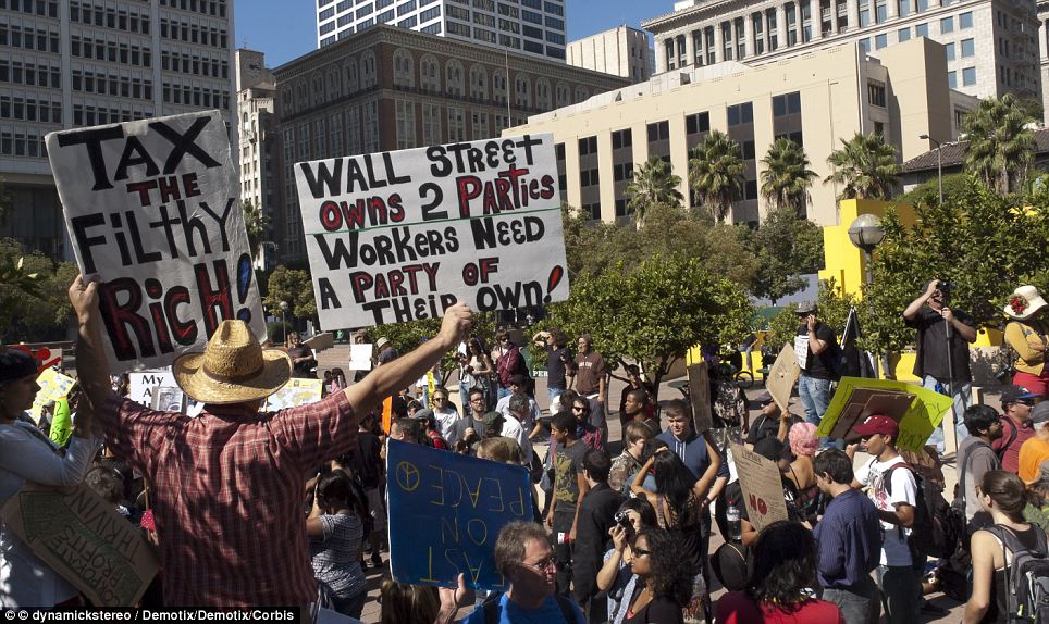 “Occupy LA” protesters marched from Pershing Square to City Hall on Saturday, and said they would remain camped at the site “indefinitely”, like their New York counterparts