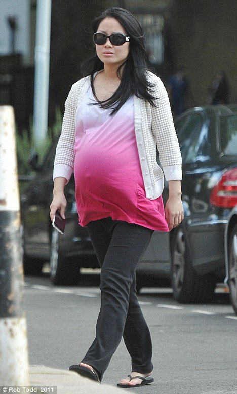 A heavily pregnant Tinglan Hong was photographed strolling in London in September