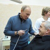 Russian Prime Minister Vladimir Putin took a picture pretending to give Yevgeny Savchenko, Governor of Belgorod, an oral hygiene check at a dentistry center during a campaign visit