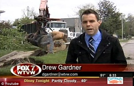 WTVW reporter Drew Gardner was doing a storm damage report in Carmi, Illinois, as a man was using a chainsaw near a fallen tree behind him