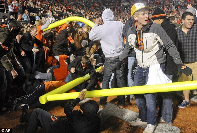 At least 13 people have been injured, including two in critical condition, after thousands of fans stormed the field and tore down goalposts after Oklahoma State's 44-10 victory over archrival Oklahoma last night