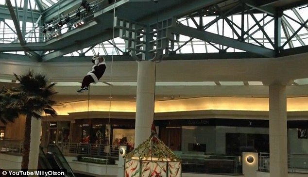 Santa was embarrassed when his beard and hair got stuck in rope while repelling into Palm Beach Gardens Mall, Florida, while horrified children watch