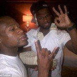 50 Cent has showed off his money literally in a series of vulgar poses on his Twitter page