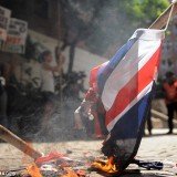 Around 100 left-wing activists have protested by burning Union flags outside the British embassy in Buenos Aires on Friday to demand Argentina break off diplomatic relations with the UK over the Falkland Islands dispute