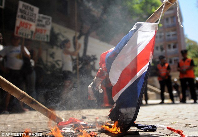 Around 100 left-wing activists have protested by burning Union flags outside the British embassy in Buenos Aires on Friday to demand Argentina break off diplomatic relations with the UK over the Falkland Islands dispute
