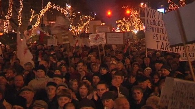 Over 30,000 people have been protesting in Budapest over Hungary's controversial new constitution, a day after it came into force