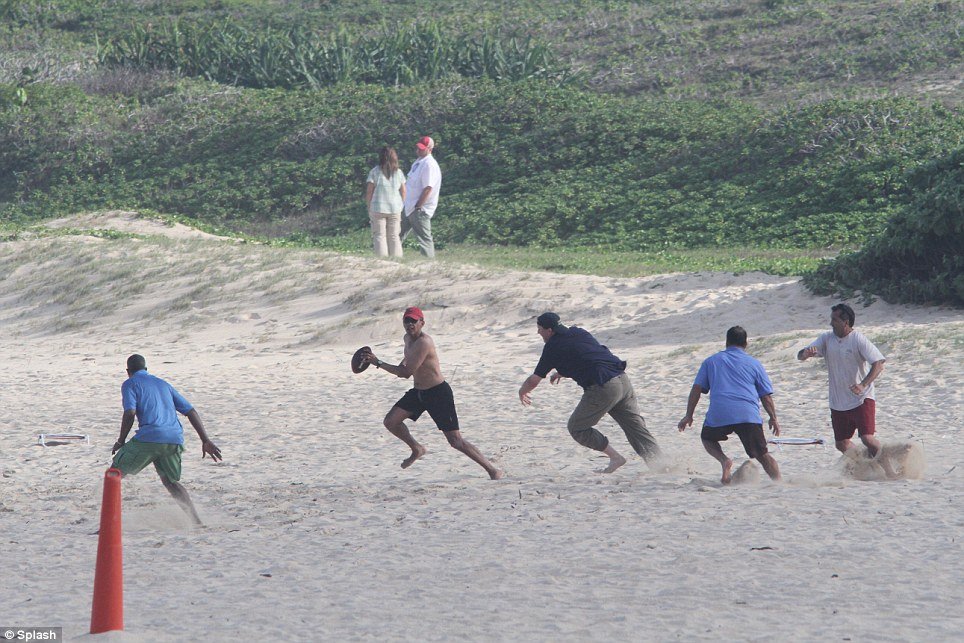 President Barack Obama stripped off for some beach football to round off his Christmas holidays in Hawaii