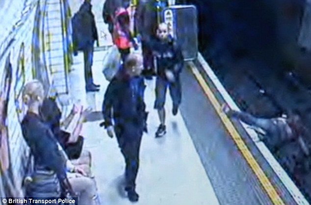 A crazed commuter launched an apparently random attack on a young woman, pushing her on to the tracks of the London Underground