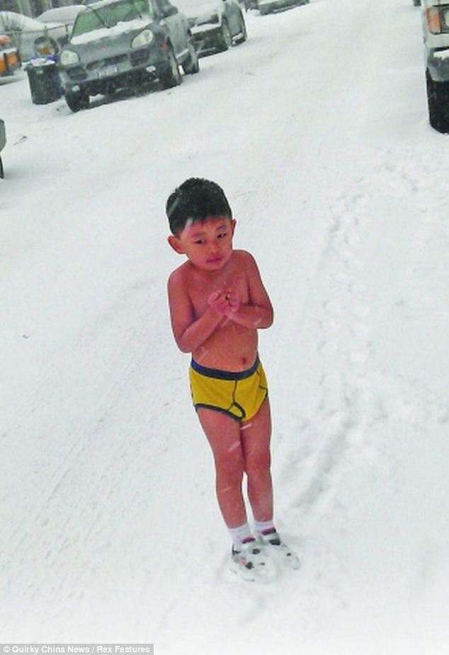 A four-year-old Chinese boy was forced by his father to run around and do push-ups in the snow, wearing only his underpants