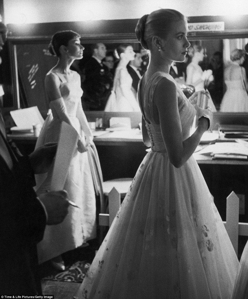 Audrey Hepburn and Grace Kelly wait with apparent nerves backstage to present an award