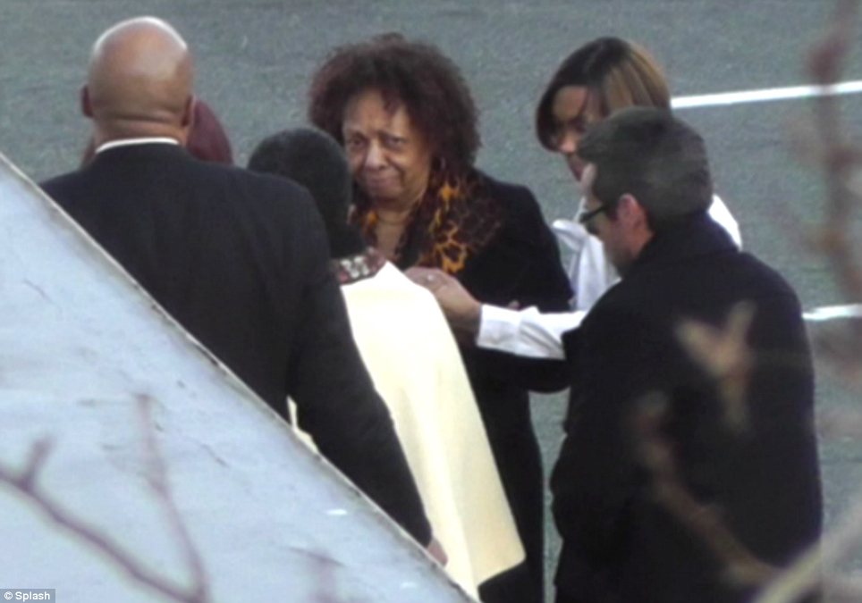 Cissy Houston was escorted into Whigham Funeral Home by a priest and held hands with a woman in a crisp white shirt