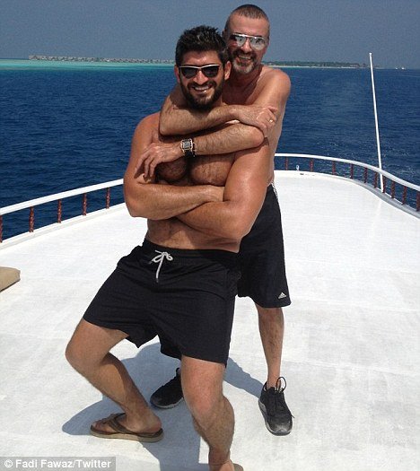 George Michael is seen smiling widely while hugging Fadi Fawaz, who is also beaming with delight