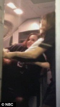 A cell phone video showing for the first time the flight attendant who caused panic aboard AA flight has emerged today