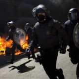 Spanish riot police have clashed with protesters in Barcelona on the day of a general strike called in protest at the government's labor market reforms