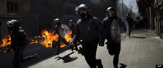 Spanish riot police have clashed with protesters in Barcelona on the day of a general strike called in protest at the government's labor market reforms