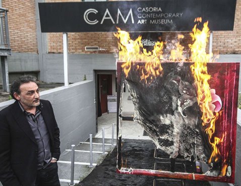 Casoria Contemporary Art Museum director Antonio Manfredi sets fire to a Severine Bourguignon painting