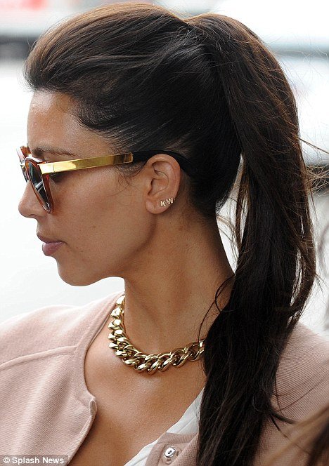 Kim Kardashian wearing Kanye West's initials in her ear 