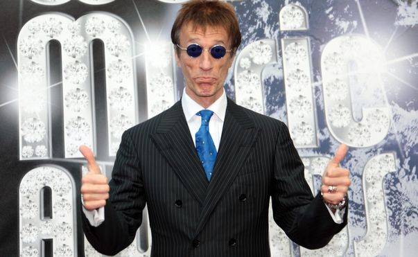 Robin Gibb has woken from a coma after more than a week and begun to show signs of recovery