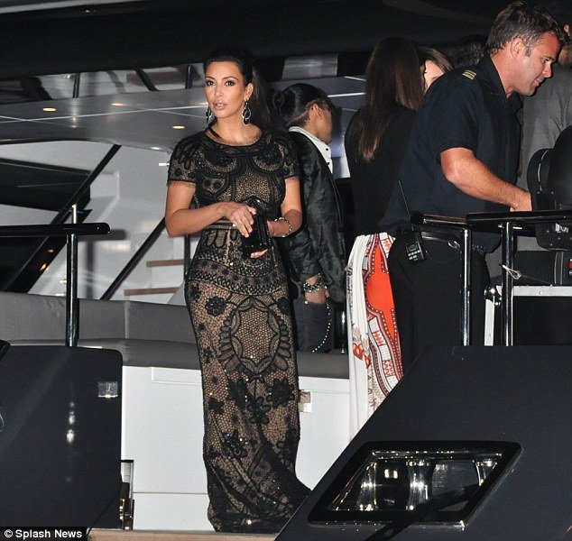 Kim Kardashian poured her ample curves into a stunning lace outfit which consisted of a crop top and matching maxi skirt