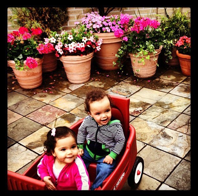 Mariah Carey's 13-month-old twins, Monroe and Moroccan, as they hitched a ride on a red wagon
