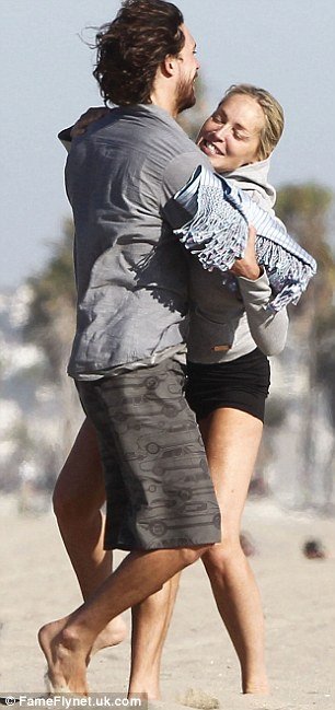 Sharon Stone was spotted getting more than a little frisky on the beach with her Argentinian boyfriend Martin Mica in Los Angeles