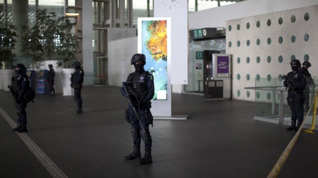Three policemen have been killed in a shootout with two other officers at Mexico City's main airport