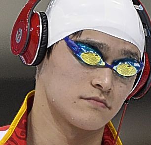 A number of Olympic swimmers at London Games are walking out to the pool wearing headphones