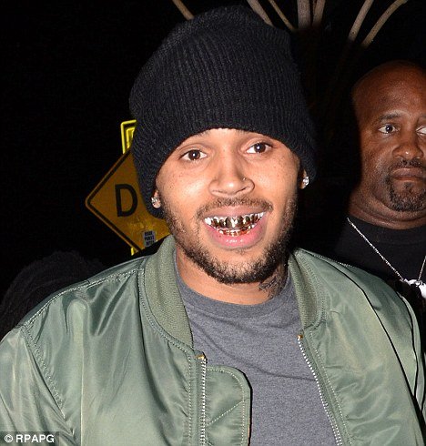 Chris Brown joined other rappers in the trend by proudly flashing his golden chompers to the dancing crowds at AV Nightclub
