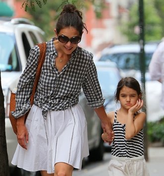 Katie Holmes and Suri are believed to have been riding in the back of a black Mercedes sedan when it was struck by a sanitation truck