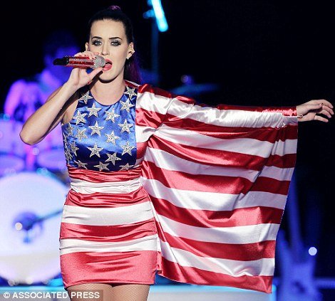 Katy Perry giving a star-spangled performance in the Brooklyn Navy Yard, donning her uniform of a purple ponytail and an American flag mini-dress