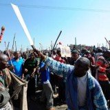 Miners arrested at Lonmin Marikana mine in South Africa will be charged later with the murder of 34 colleagues shot by police