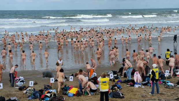 Hundreds of swimmers have braved the cold of the Northumberland coast in an attempt at a record-breaking skinny dip