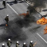 Police have fired tear gas in Greece to disperse anarchists throwing petrol bombs near parliament in Athens