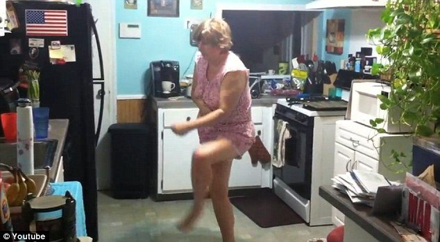 The hysterical video, uploaded on YouTube, shows the pajama-clad woman wandering and then waltzing around her kitchen, while her son follows her with a camera