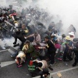 Thai police have used tear gas against thousands of protesters calling for the overthrow of Prime Minister Yingluck Shinawatra in Bangkok