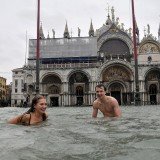 Venice may be known as the Floating City of love, but romance was cast aside today as gondolas were swapped for wellington boots and swimwear