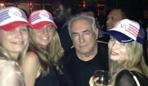 DSK was caught on camera brazenly posing with the attractive young women during a night out with pals in Paris
